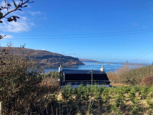 a house with a view of a body of water at 3 Bed in Waternish 93005 in Stein