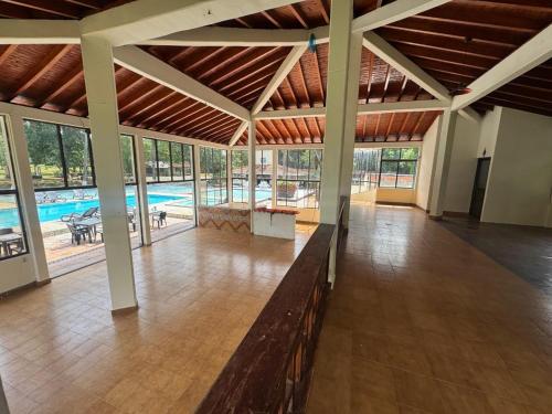 a large building with a swimming pool and a large room at Hotel Aero Santa Fe in Santa Fe de Antioquia