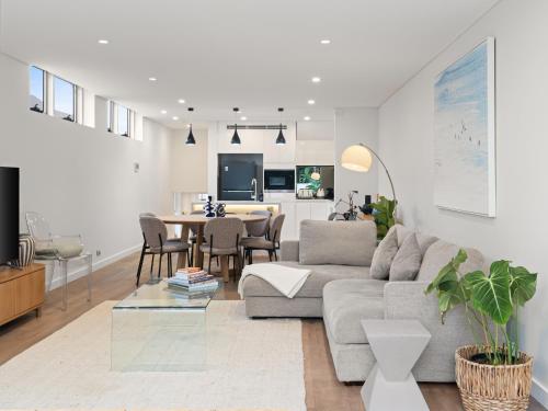 a living room with a couch and a table at The Nancy Bondi in Sydney