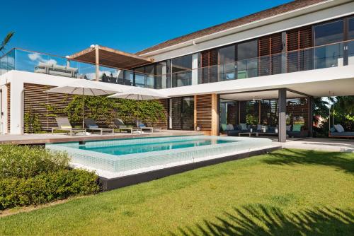 a house with a swimming pool in the yard at A magnificent villa that is perfect to enjoy a quiet vacation in Leeward
