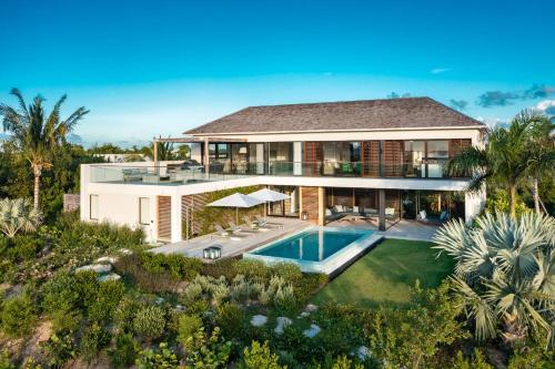 an aerial view of a house with a swimming pool at A magnificent villa that is perfect to enjoy a quiet vacation in Leeward