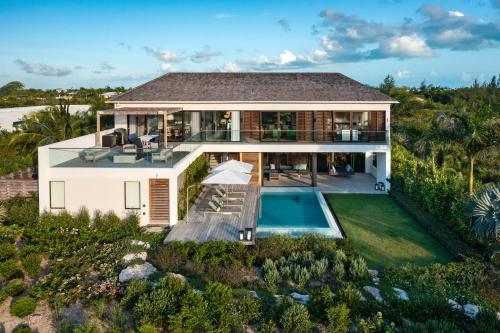 an aerial view of a house with a swimming pool at A magnificent villa that is perfect to enjoy a quiet vacation in Leeward