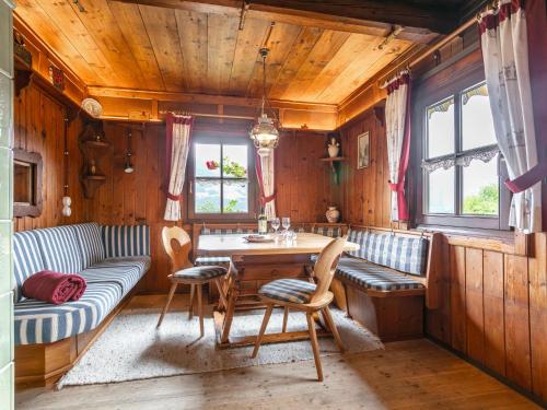 a room with a table and chairs and a couch at Weberhäusl am Penningberg in Hopfgarten im Brixental