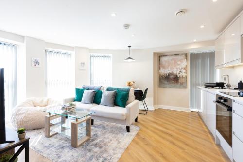 a living room with a white couch and a table at Stylish Central Leeds Arena Apartment Free Parking in Leeds