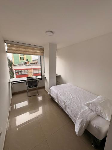 a bedroom with a bed and a window at Seganis casa hotel in Bogotá