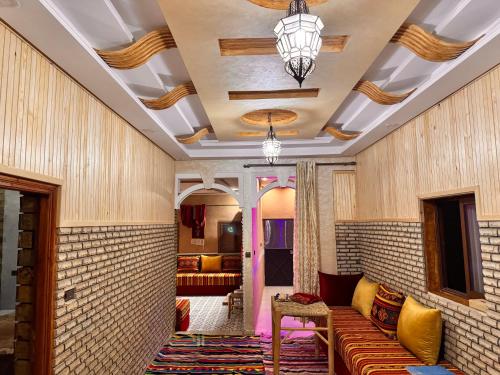 a living room with a couch and a ceiling at Toubkal home stay in Imlil