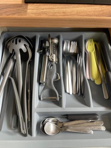 a drawer filled with utensils in a kitchen at Self-catering Apartment in the Heart of London Victoria in London