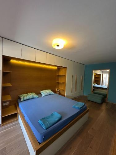 a bedroom with a large bed with a wooden headboard at Venus Luxury Apartment in Skopje