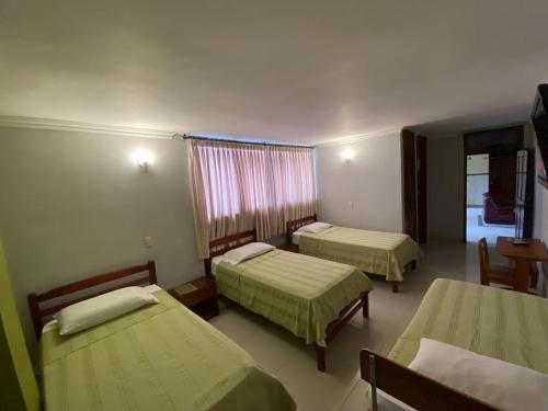 a hospital room with two beds and a window at Hotel San Francisco in Barranquilla