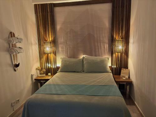 Katil atau katil-katil dalam bilik di Casa de praia com ar condicionado.