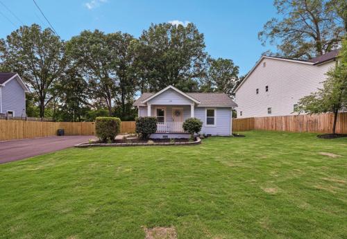 a home with a fence and a yard at Marietta Charmer in Marietta