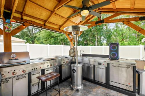 a large kitchen with stainless steel appliances and a ceiling fan at Serenity Escape in Palm Coast