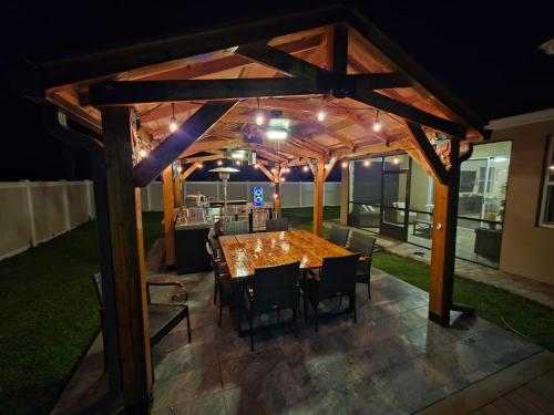 a wooden pergola with a table and chairs at Serenity Escape in Palm Coast