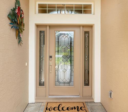 a door with a welcome sign in front of it at Serenity Escape in Palm Coast