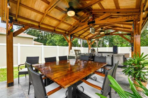 a wooden table and chairs on a patio at Serenity Escape in Palm Coast