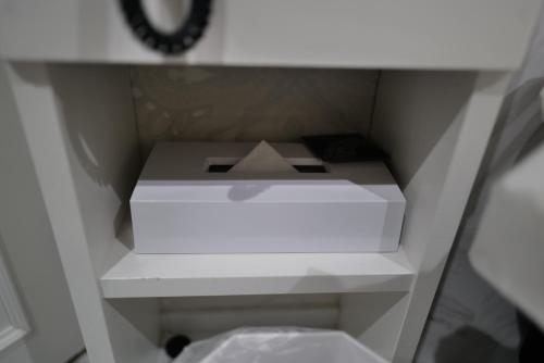 a white box sitting on a shelf in a cabinet at HOTELO OTONA no ASOBIBA in Yosano