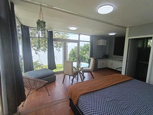 a bedroom with a bed and a living room at Abitare lodge Mezcala #2 in Isla de Mezcala