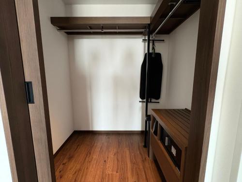 a room with a tv and a closet at Citadines Harbour Front Yokohama in Yokohama