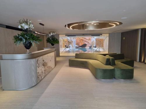 a lobby with couches and a bar in a building at ירדן דירת גן אדריכלית סוויטה פרטית in Eilat