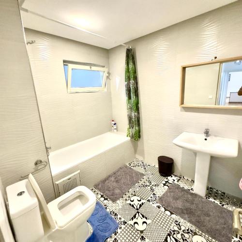 a bathroom with a white toilet and a sink at Appartement centre ville avec Wifi 100Mo in Fès