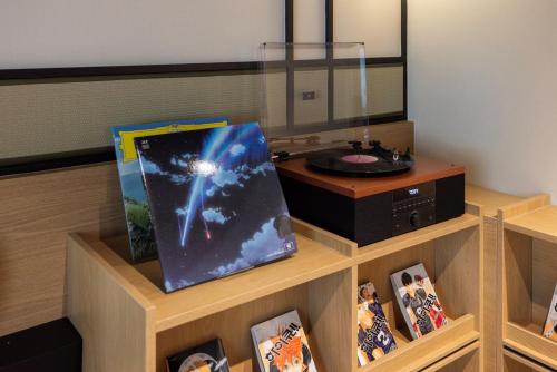 a room with a table with pictures and a record player at Mitasuya Ryokan Hotel by Aank Cheonan in Cheonan