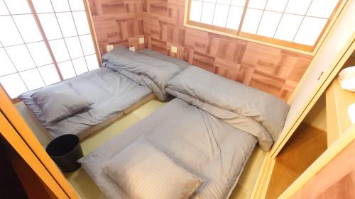 two beds in a small room with a window at 22minutes by car to Nagoya Station 2parking 