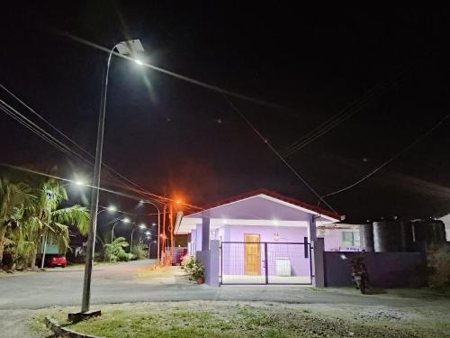 a small house at night with a street light at Homestay Impian Bapa in Semporna