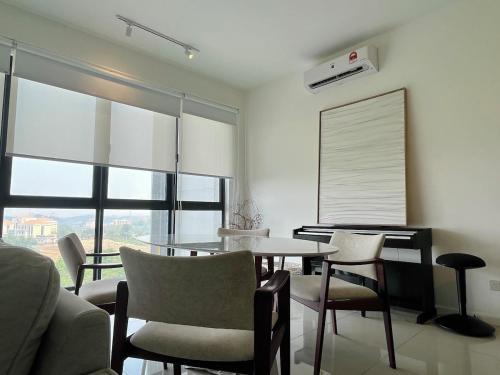 a dining room with a table and chairs and a window at NEW Designer Condo - Panoramic Forest View - Steps To IOI City Mall - Your Best Urban Retreat in Putrajaya