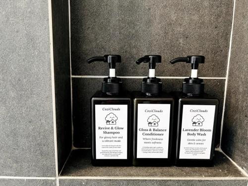 two bottles ofodorizers are sitting on a wall at NEW Designer Condo - Panoramic Forest View - Steps To IOI City Mall - Your Best Urban Retreat in Putrajaya