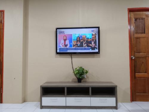 a flat screen tv hanging on a wall at Homestay Impian Bapa in Semporna