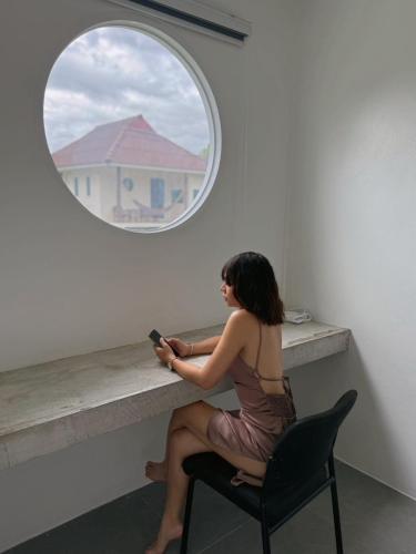 a woman sitting in a chair looking at her cell phone at JJ and J Garden1 Pai in Pai