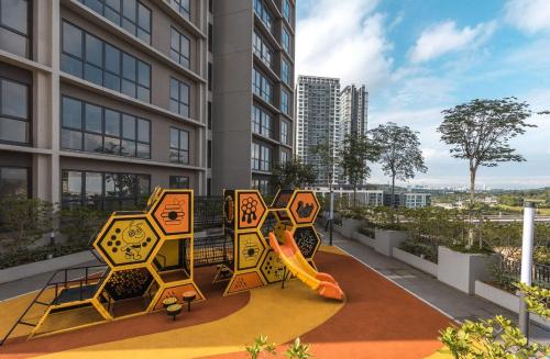a playground in the middle of a building with a slide at NEW Designer Condo - Panoramic Forest View - Steps To IOI City Mall - Your Best Urban Retreat in Putrajaya