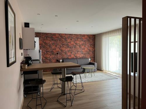 a kitchen and living room with a table and chairs at Gîte de luxe in Leimbach