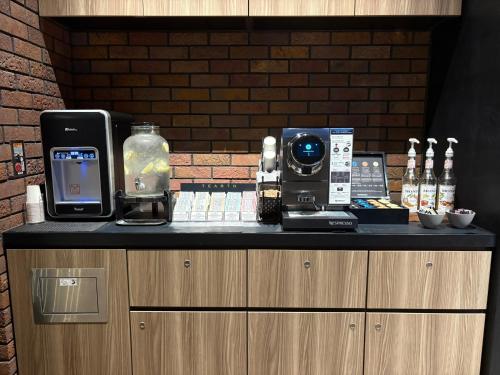 a counter with a cell phone and other items on it at Citadines Harbour Front Yokohama in Yokohama