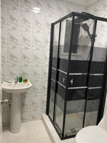 a bathroom with a shower and a sink at Casa Villarrica, villa los Chilcos in Villarrica