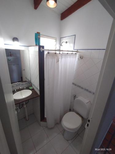 a bathroom with a toilet and a sink at Carnaval in Gualeguaychú
