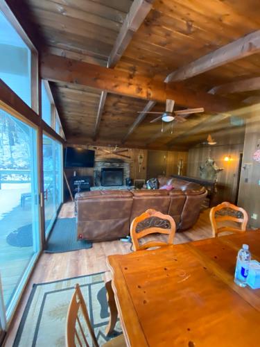 a dining room with a table and a couch at Cabin on the hill Ascutney 