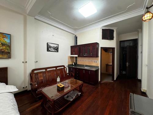 a room with a bed and a table in it at Hanoi ILDIVO 8 Hang Dao in Hanoi