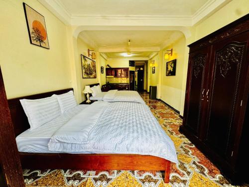 a bedroom with a large bed with white sheets at Hanoi ILDIVO 8 Hang Dao in Hanoi