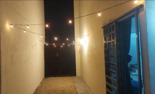 a hallway with christmas lights on the side of a building at Residencia en Apodaca 15 min del aeropuerto! in Monterrey