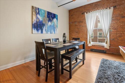 a dining room with a black table and chairs at Top Floor Loft in Downtown Indianapolis in Indianapolis