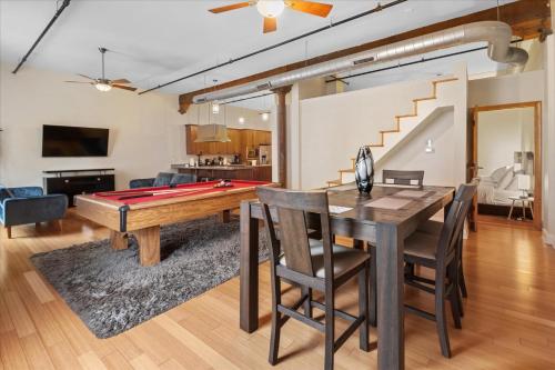 a living room with a pool table and ping pong ball at Top Floor Loft in Downtown Indianapolis in Indianapolis