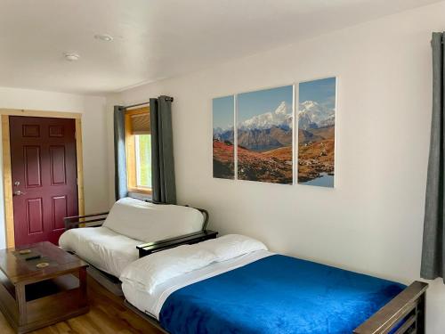 a bedroom with two beds and a red door at Talkeetna Wilderness Lodge & Cabin Rentals in Sunshine