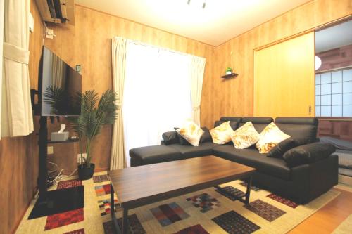 a living room with a couch and a table at 22minutes by car to Nagoya Station 2parking 