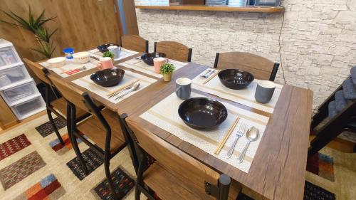a wooden table with plates and utensils on it at 22minutes by car to Nagoya Station 2parking 