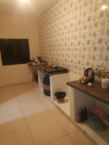 a room with a table and a tv on a wall at Habitación con baño privado mas servicio de taxi aeropuerto in Santa Cruz de la Sierra
