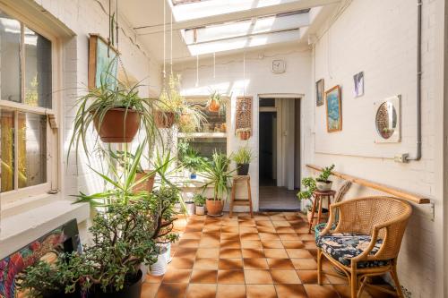 an indoor garden with potted plants in a room at Art House in Melbourne
