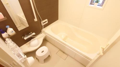 a bathroom with a tub and a toilet and a sink at 22minutes by car to Nagoya Station 2parking 