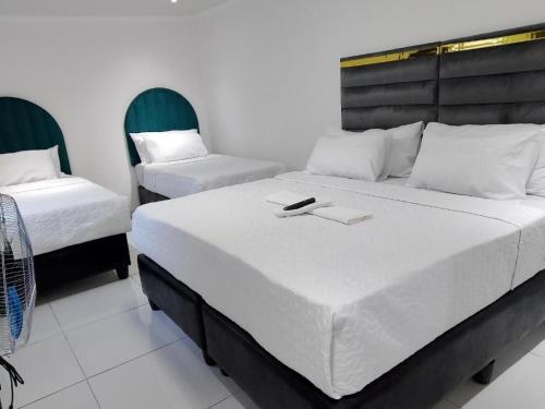 a bedroom with two beds and two chairs at Duminy House Guest Lodging in Bellville