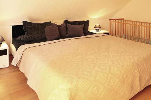 a bedroom with a large bed with two night stands at Cottages at the Kummerower See in Verchen in Verchen